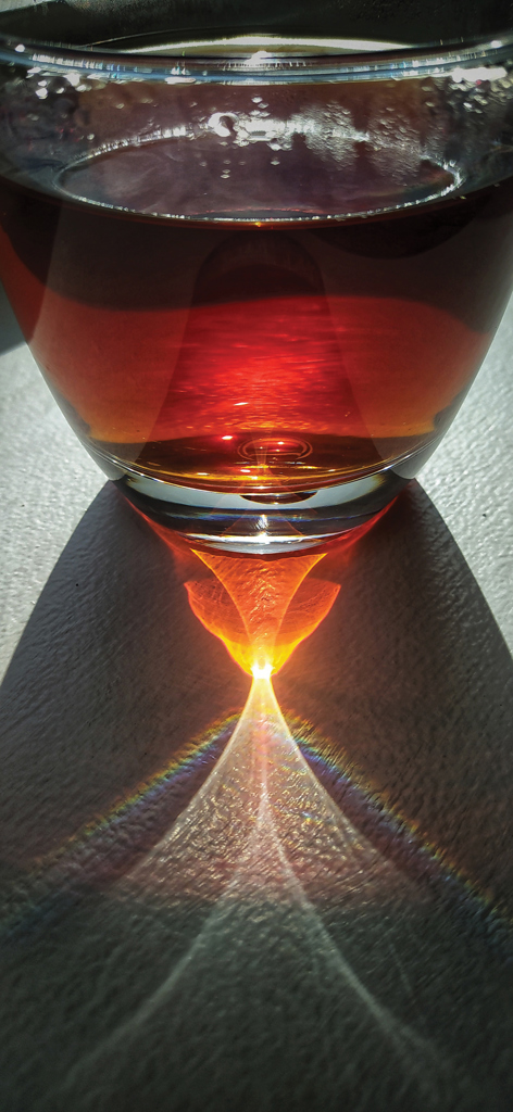 The curved surface of a glass of tea 