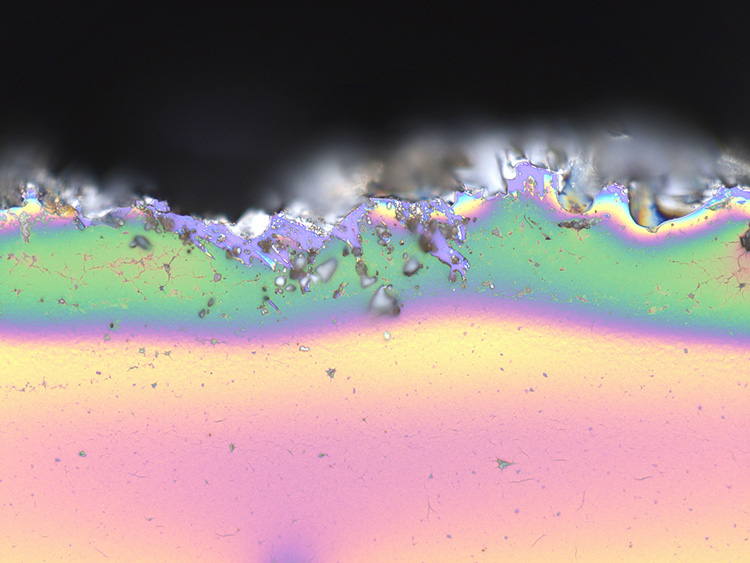This image shows a number of optical phenomena, starting with a green laser (532-nm Nd:YAG) guided by a multimode silica optical fiber to a vial containing an organic dye